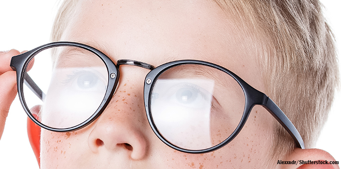 boy adjusting his glasses